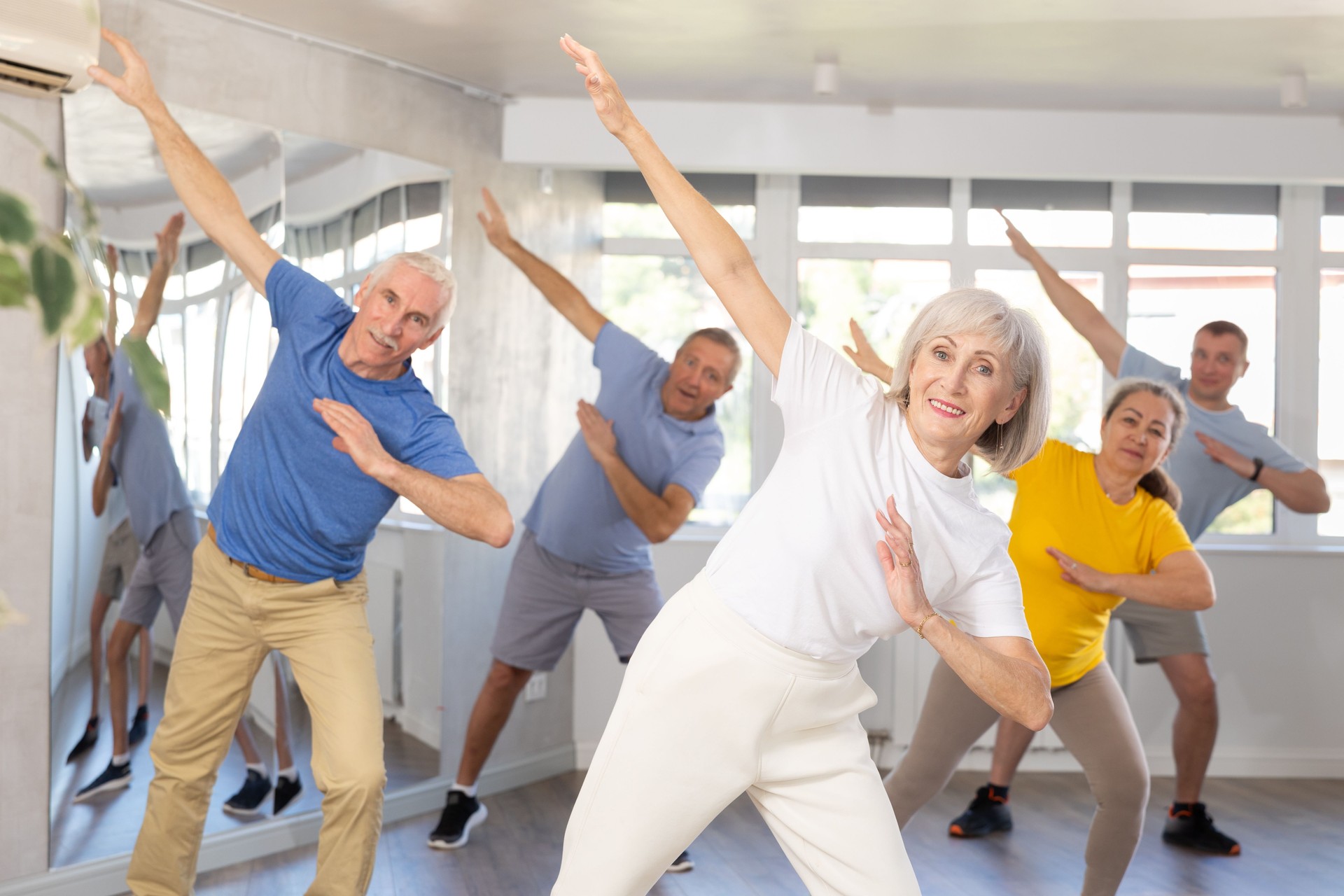 Woman participating in Zumba class for seniors in fitness studio